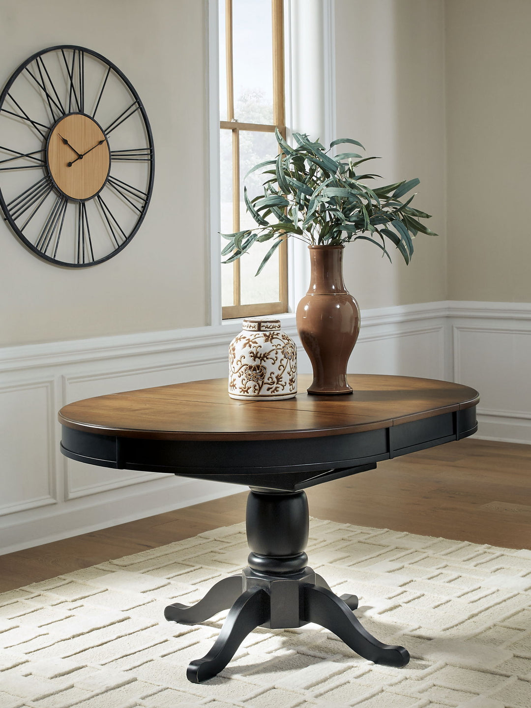 Clorazi - Oval Dining Room Butterfly Extension Table - Black / Brown - Roberts Furniture & Mattress (Yorktown, VA)